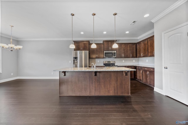 506 Foxridge Dr SW, Hartselle, AL 35640 - kitchen with dark brown cabinetry, a notable chandelier, a kitchen island with sink, stainless steel appliances, and baseboards