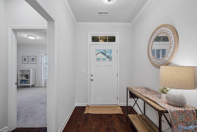 carpeted entryway with visible vents, crown molding, baseboards, and wood finished floors