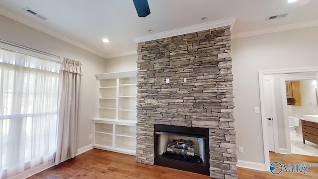 unfurnished living room with wood-type flooring, a fireplace, ornamental molding, and ceiling fan