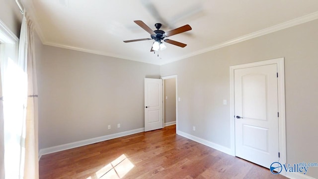 unfurnished bedroom with ceiling fan, hardwood / wood-style floors, and crown molding