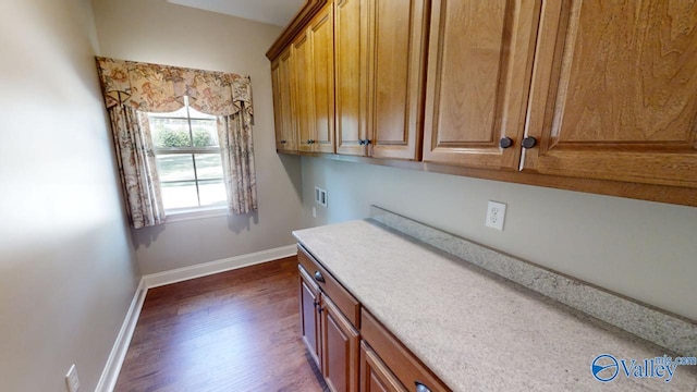 laundry area featuring hookup for a washing machine, cabinets, and dark hardwood / wood-style floors