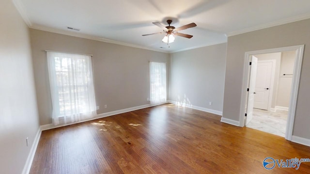 interior space featuring wood-type flooring, ornamental molding, and ceiling fan