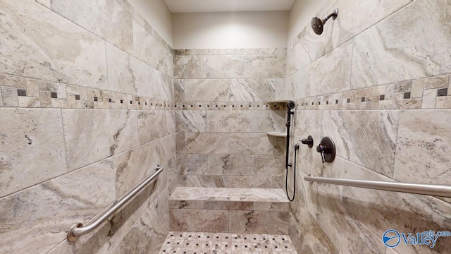 interior details with a tile shower