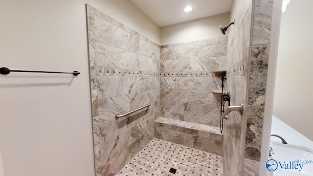 bathroom with a tile shower