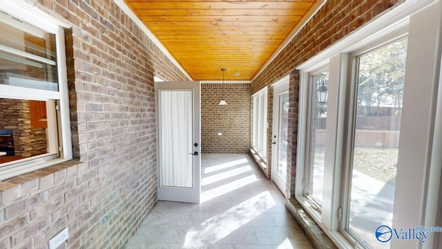 sunroom / solarium with a wealth of natural light and wooden ceiling