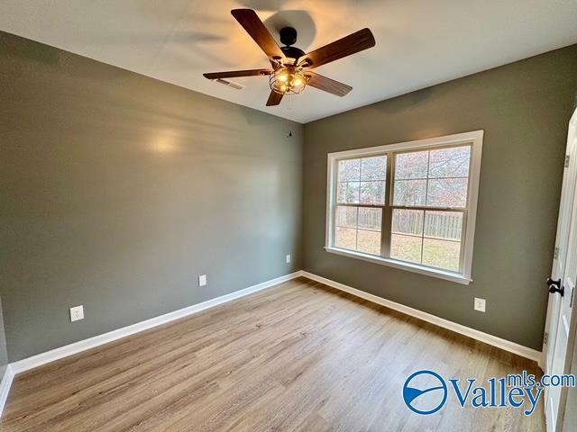 spare room featuring ceiling fan and light wood-type flooring