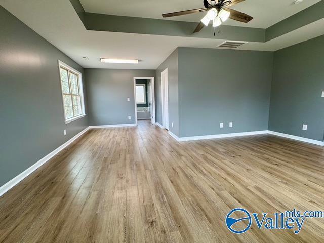 spare room with ceiling fan and light wood-type flooring