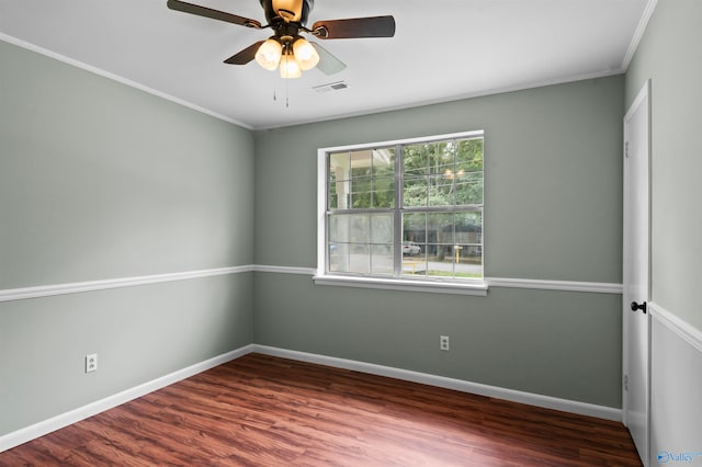 empty room with ceiling fan, hardwood / wood-style flooring, and crown molding