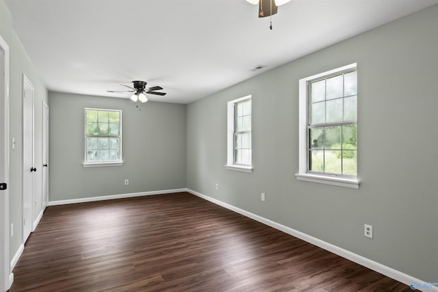 empty room featuring a ceiling fan and a wealth of natural light