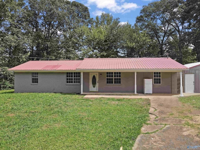 ranch-style home with a front yard and metal roof