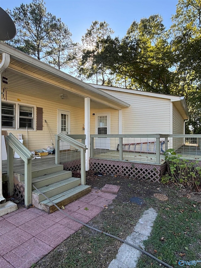 entrance to property featuring a wooden deck