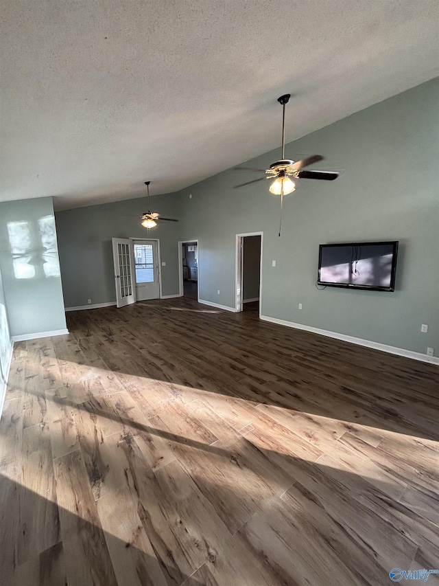 175 County Road 371, Centre, AL 35960 - unfurnished living room featuring lofted ceiling, ceiling fan, wood finished floors, baseboards, and a textured ceiling
