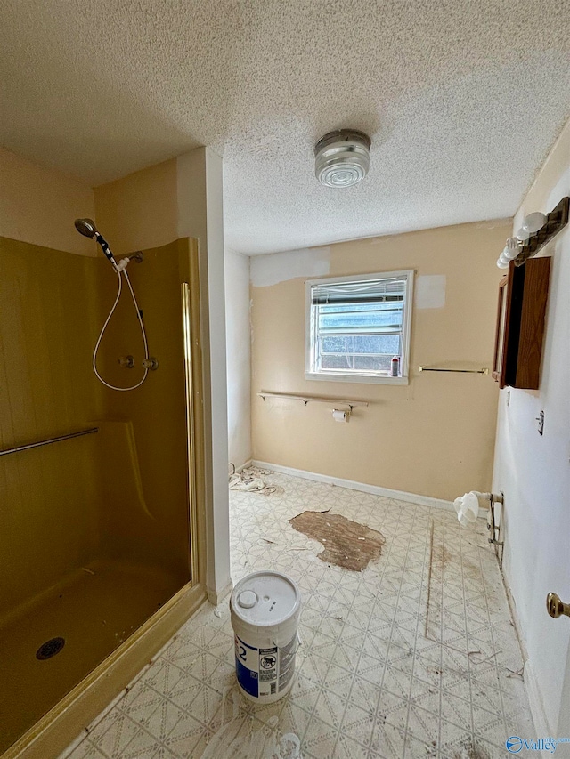 bathroom featuring walk in shower and a textured ceiling