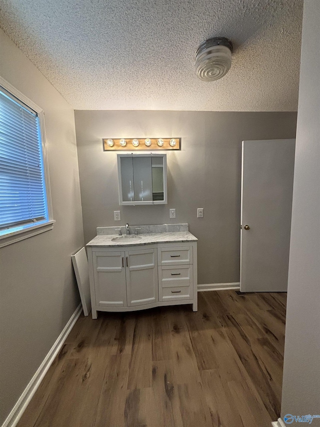 175 County Road 371, Centre, AL 35960 - bathroom with a textured ceiling, wood finished floors, vanity, and baseboards