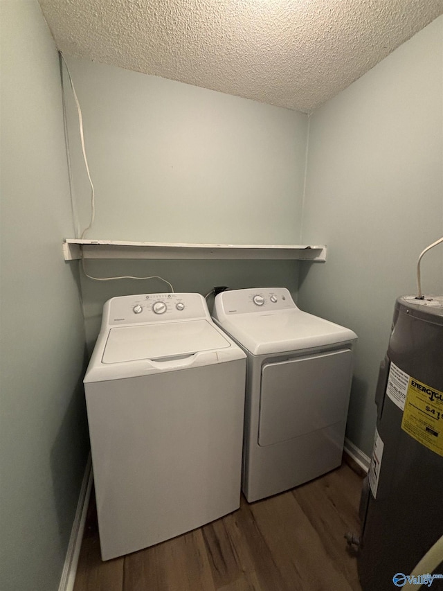 175 County Road 371, Centre, AL 35960 - washroom with electric water heater, washer and clothes dryer, wood finished floors, a textured ceiling, and baseboards
