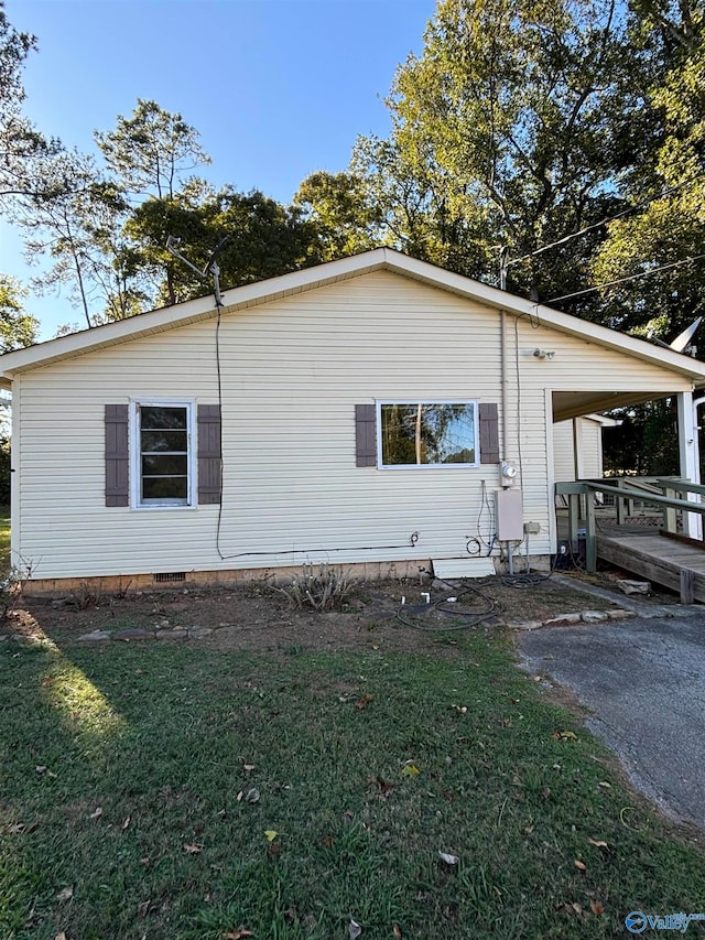 view of side of home featuring a lawn