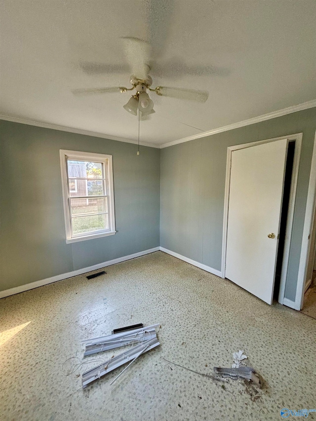 unfurnished room with a textured ceiling, ceiling fan, and crown molding