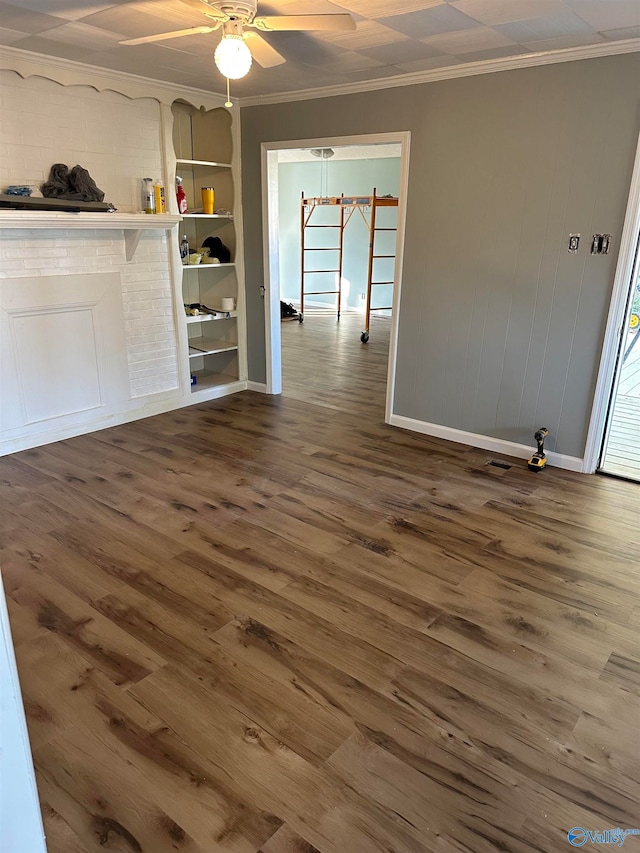 interior space featuring ceiling fan, wood-type flooring, built in features, and ornamental molding