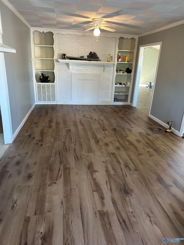 unfurnished living room with built in features, ceiling fan, wood-type flooring, and ornamental molding