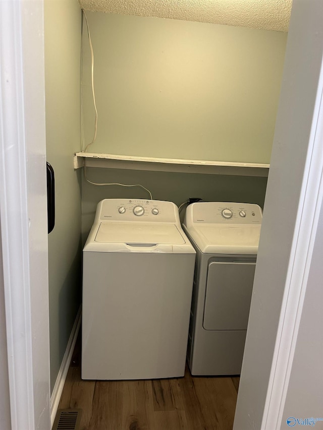 175 County Road 371, Centre, AL 35960 - laundry room with independent washer and dryer, wood finished floors, and a textured ceiling