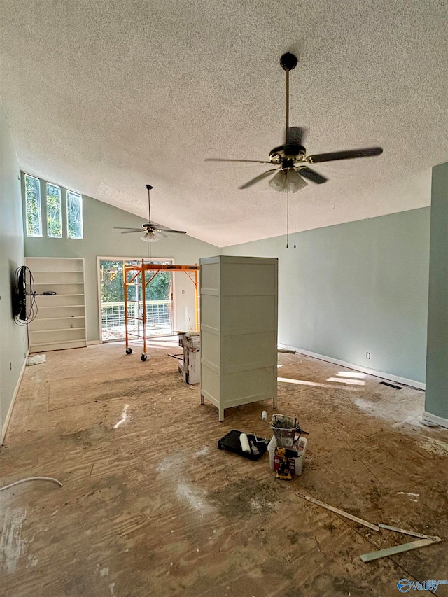 unfurnished living room featuring a textured ceiling and vaulted ceiling