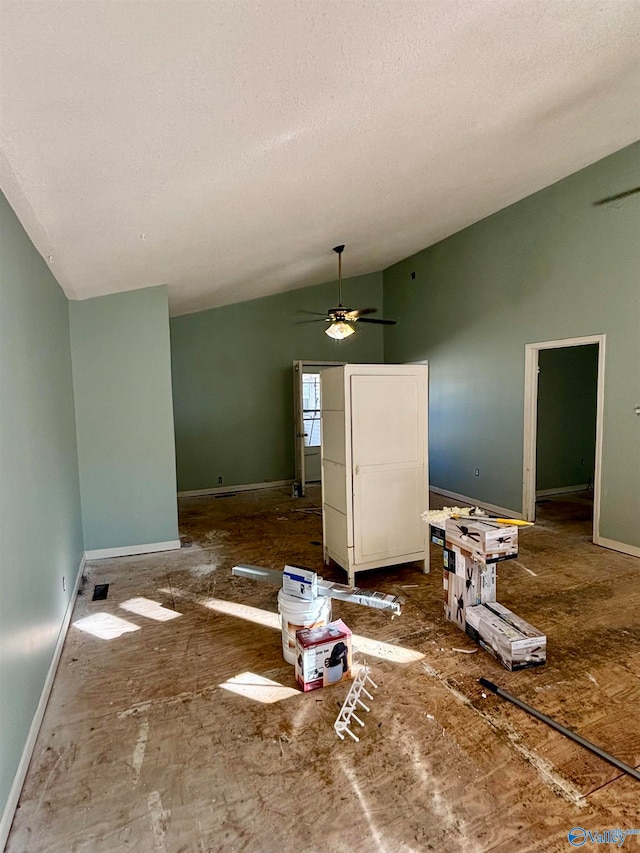 interior space with a textured ceiling, ceiling fan, and vaulted ceiling