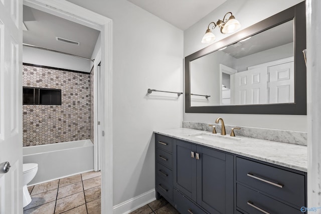 full bathroom featuring visible vents, toilet, vanity, baseboards, and tile patterned floors