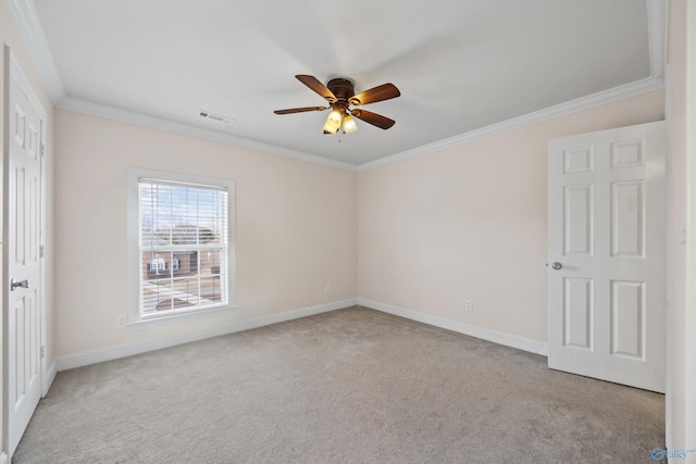 unfurnished room featuring baseboards, visible vents, a ceiling fan, ornamental molding, and carpet flooring