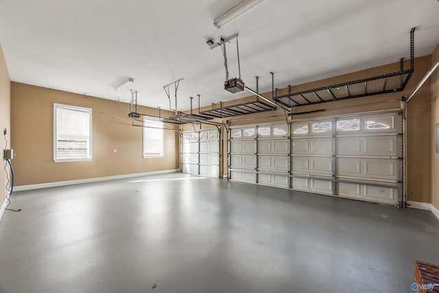 garage with a garage door opener and baseboards