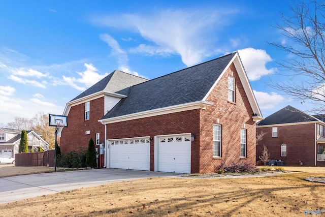 view of side of home featuring a garage, brick siding, driveway, and roof with shingles