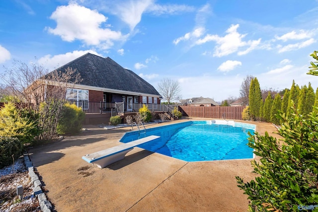 view of swimming pool with a patio area, fence, a fenced in pool, and a wooden deck