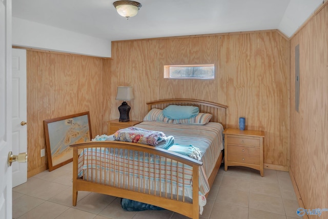 bedroom featuring light tile patterned flooring, lofted ceiling, and wooden walls