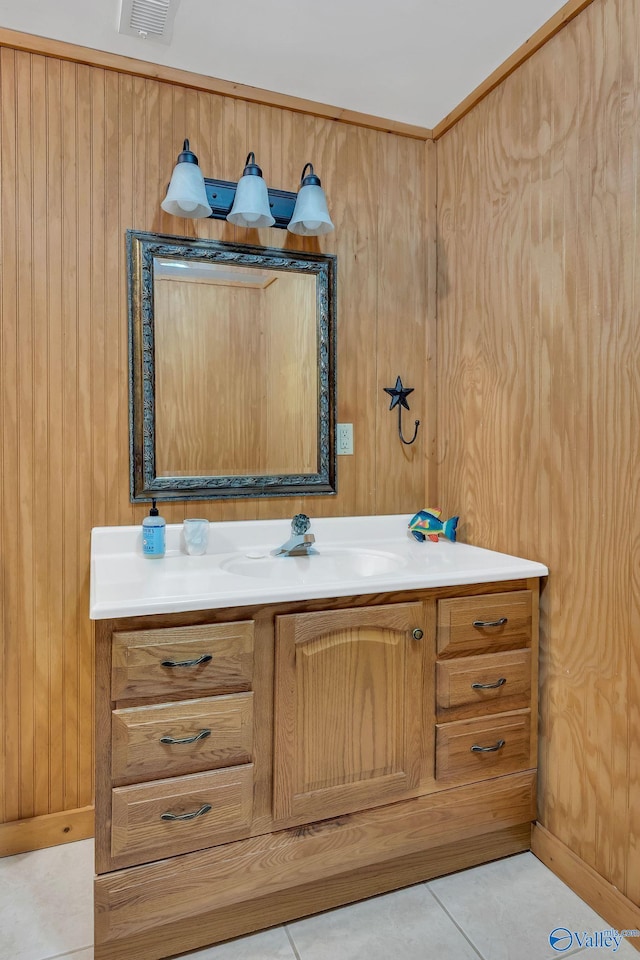 bathroom with tile patterned flooring, vanity, wood walls, and visible vents