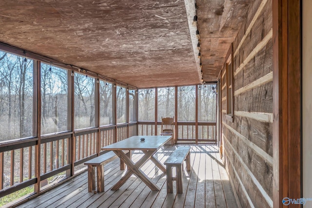 unfurnished sunroom with outdoor dining space and a healthy amount of sunlight