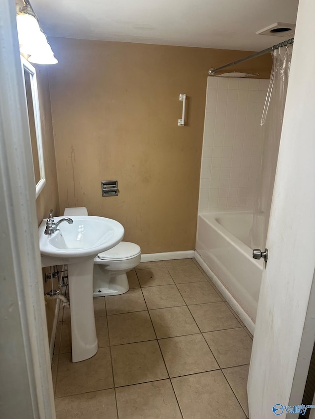 full bathroom featuring toilet, tile patterned floors, and shower / tub combo with curtain