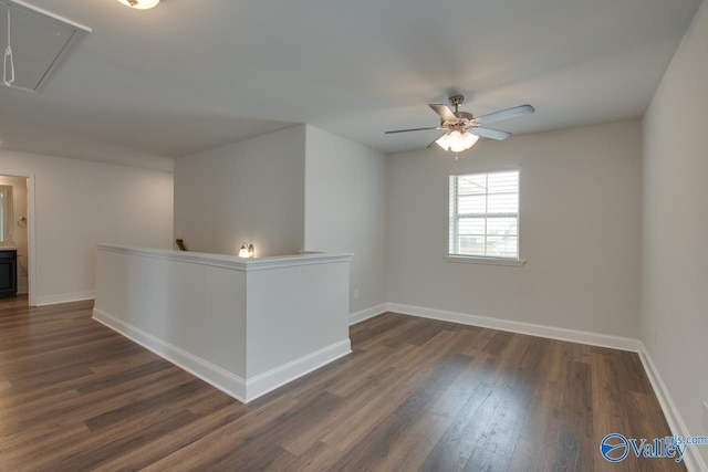 214 Tybee Dr, Madison, AL 35756 - unfurnished room featuring a ceiling fan, baseboards, dark wood finished floors, and attic access