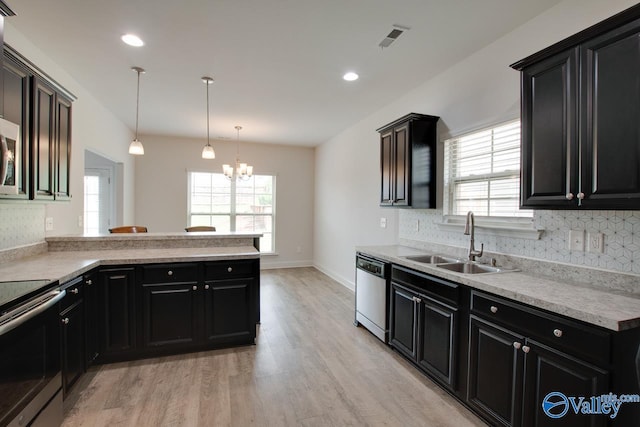 214 Tybee Dr, Madison, AL 35756 - kitchen featuring a sink, dark cabinets, stainless steel appliances, tasteful backsplash, and visible vents