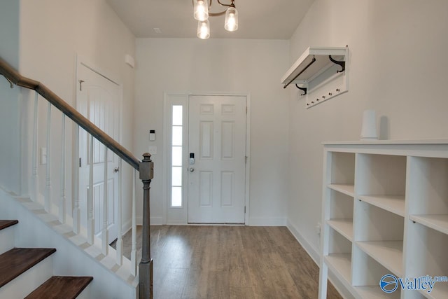 214 Tybee Dr, Madison, AL 35756 - entrance foyer featuring an inviting chandelier, baseboards, stairs, and wood finished floors