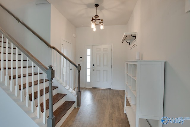 214 Tybee Dr, Madison, AL 35756 - entryway with baseboards, stairs, wood finished floors, and a chandelier