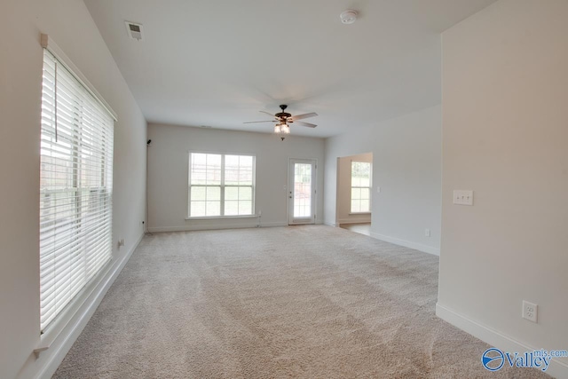 214 Tybee Dr, Madison, AL 35756 - empty room featuring baseboards, ceiling fan, light carpet, and a healthy amount of sunlight