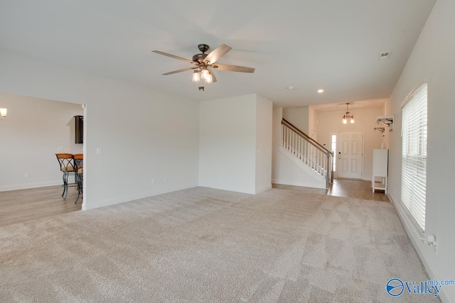214 Tybee Dr, Madison, AL 35756 - unfurnished living room with ceiling fan, light carpet, recessed lighting, baseboards, and stairway