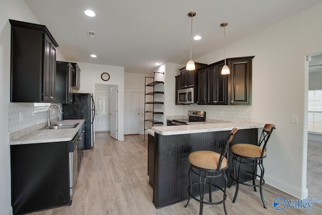 214 Tybee Dr, Madison, AL 35756 - kitchen featuring a sink, backsplash, stainless steel appliances, and light wood finished floors