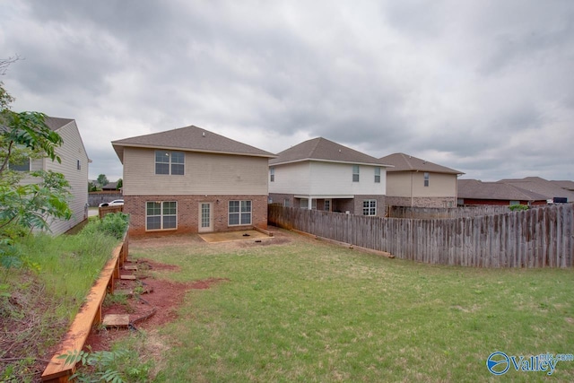 214 Tybee Dr, Madison, AL 35756 - back of house featuring brick siding, a fenced backyard, and a yard
