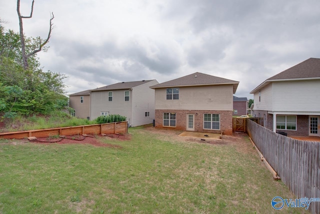 214 Tybee Dr, Madison, AL 35756 - rear view of house featuring a fenced backyard, a lawn, and brick siding