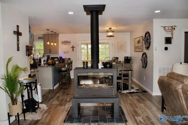 dining room with a wood stove and dark hardwood / wood-style floors