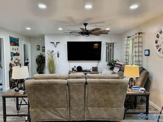 living room featuring hardwood / wood-style floors and ceiling fan