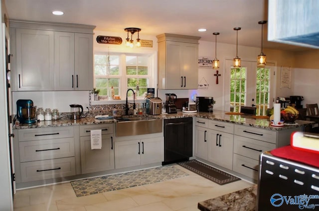 kitchen featuring sink, black dishwasher, white cabinets, kitchen peninsula, and hanging light fixtures