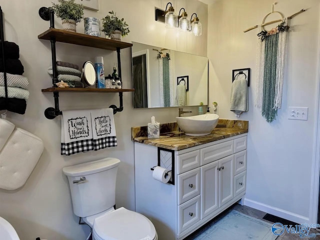 bathroom with toilet and vanity