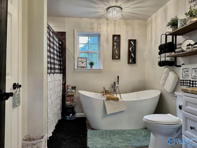 bathroom with toilet, vanity, and a bathing tub