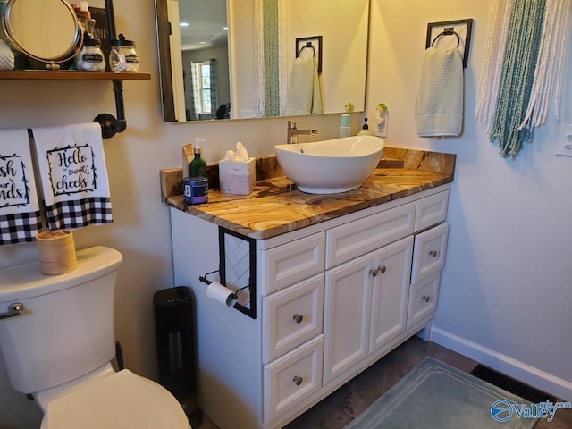 bathroom with toilet and vanity